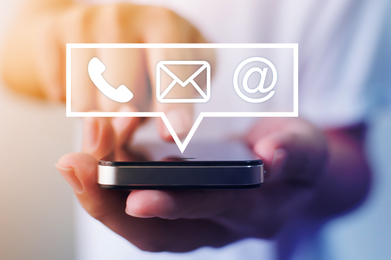 Close-up image of male hands using smartphone with icon telephone email mobile phone and address. Contact us connection and e-mail marketing concept stock photo